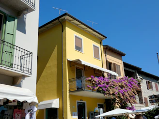 A vibrant street scene in Concepción de Buenos Aires, Jalisco, showing colorful buildings under a bright sky.