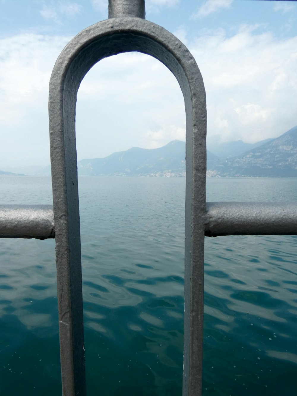 a view of a body of water through a fence