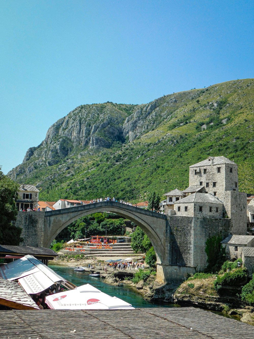 a bridge over a river with a boat in the water