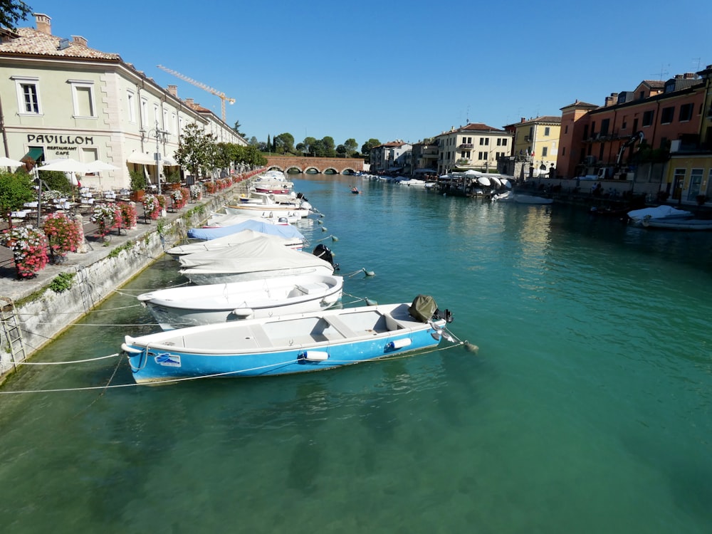 a row of boats sitting next to each other on a river