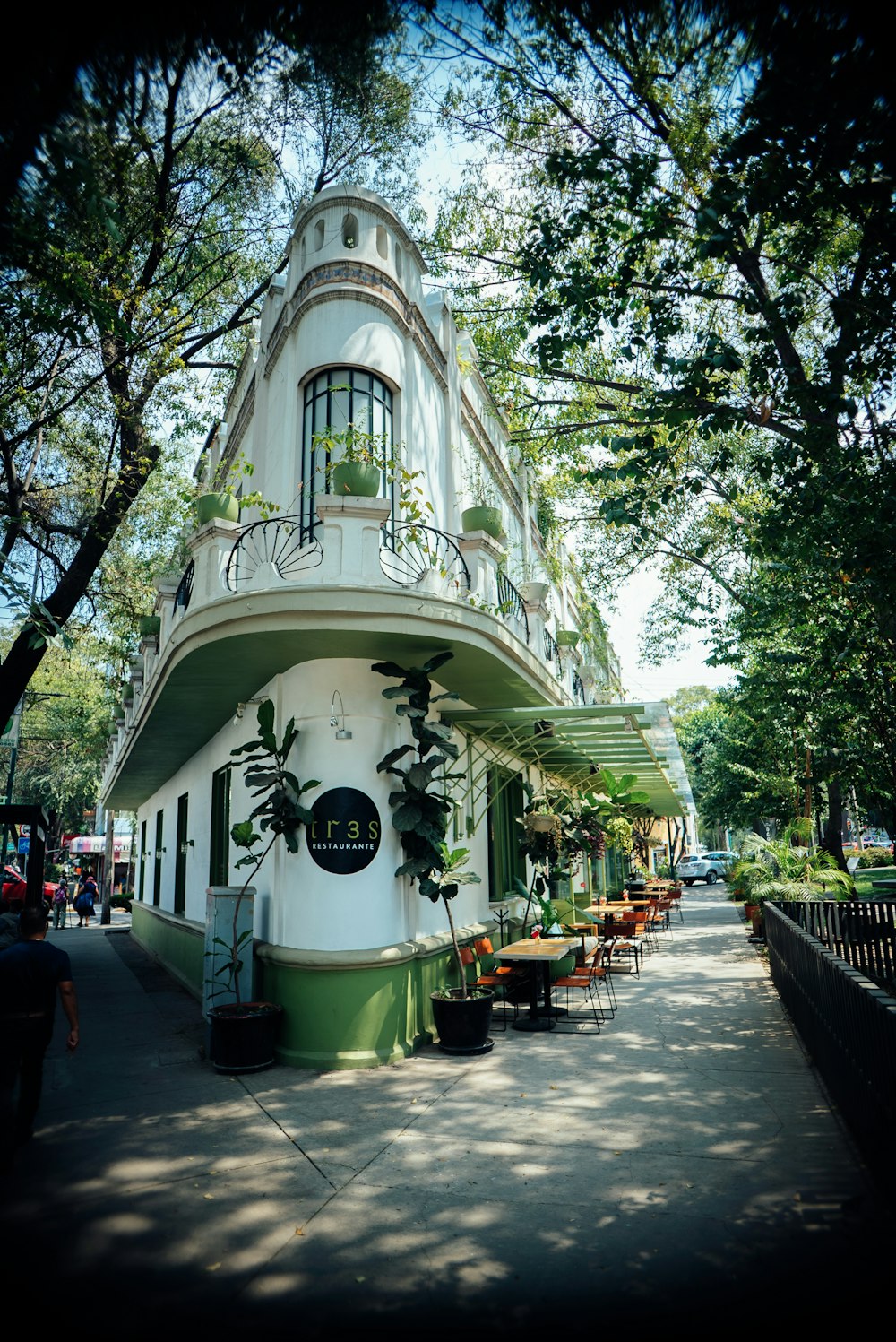 a white and green building with a balcony