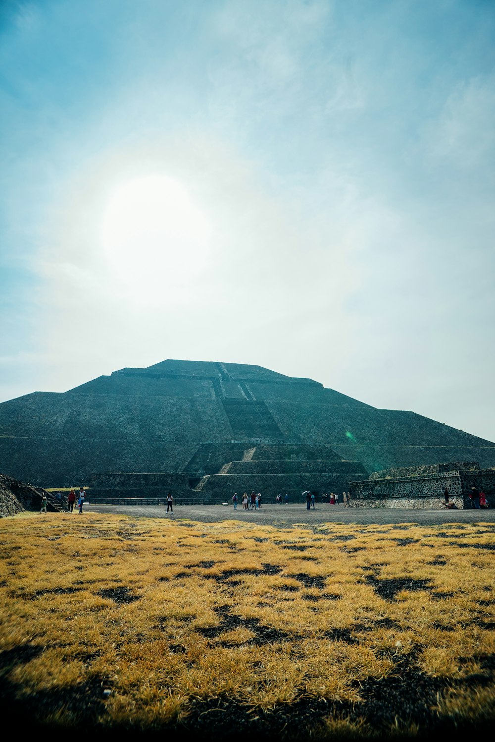 a group of people standing in front of a pyramid