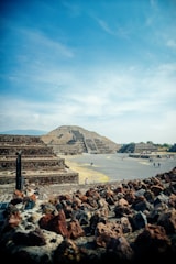 a group of people standing around a pyramid