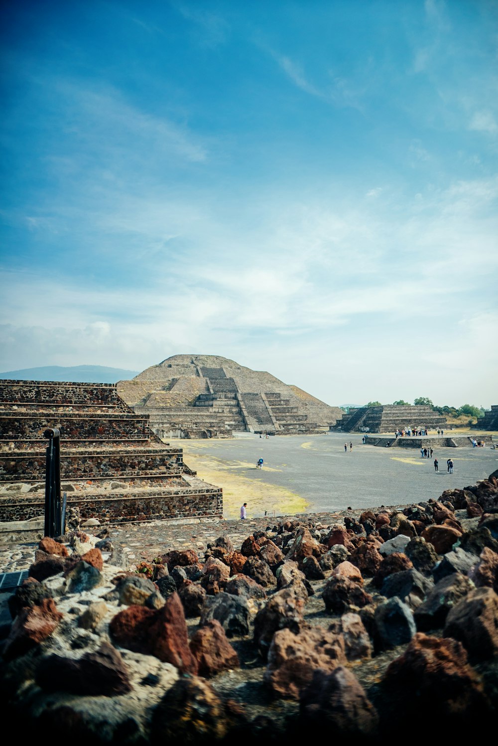 a group of people standing around a pyramid