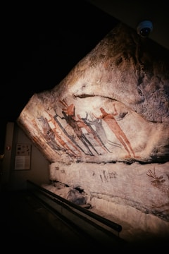 a close up of a rock with paintings on it