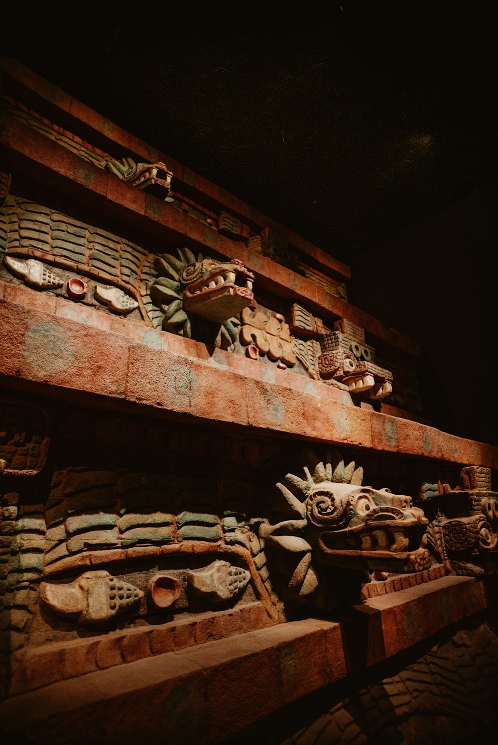 a close up of a wooden shelf with carvings on it