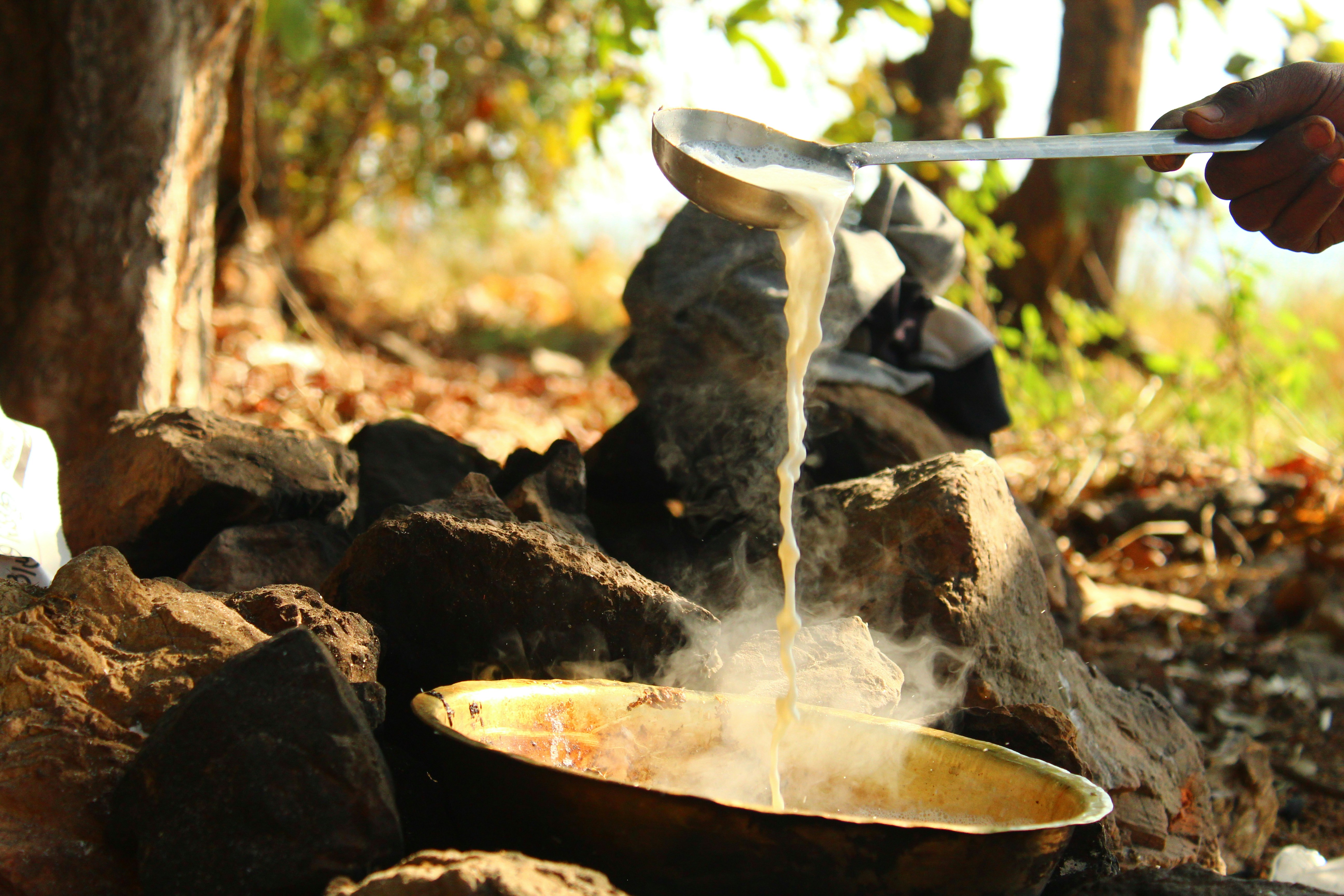 a person is pouring water into a bowl