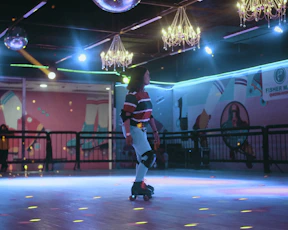 a man riding a skateboard on top of a dance floor