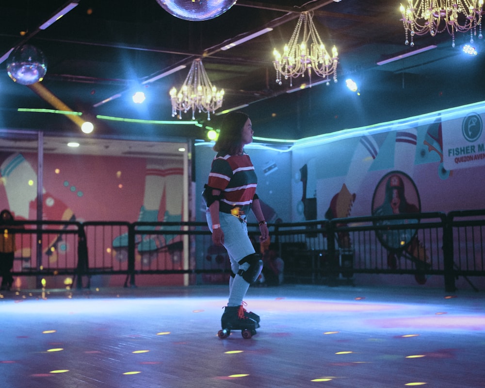 a man riding a skateboard on top of a dance floor