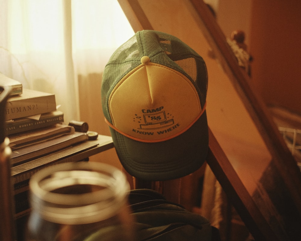 a green and yellow hat sitting on top of a chair