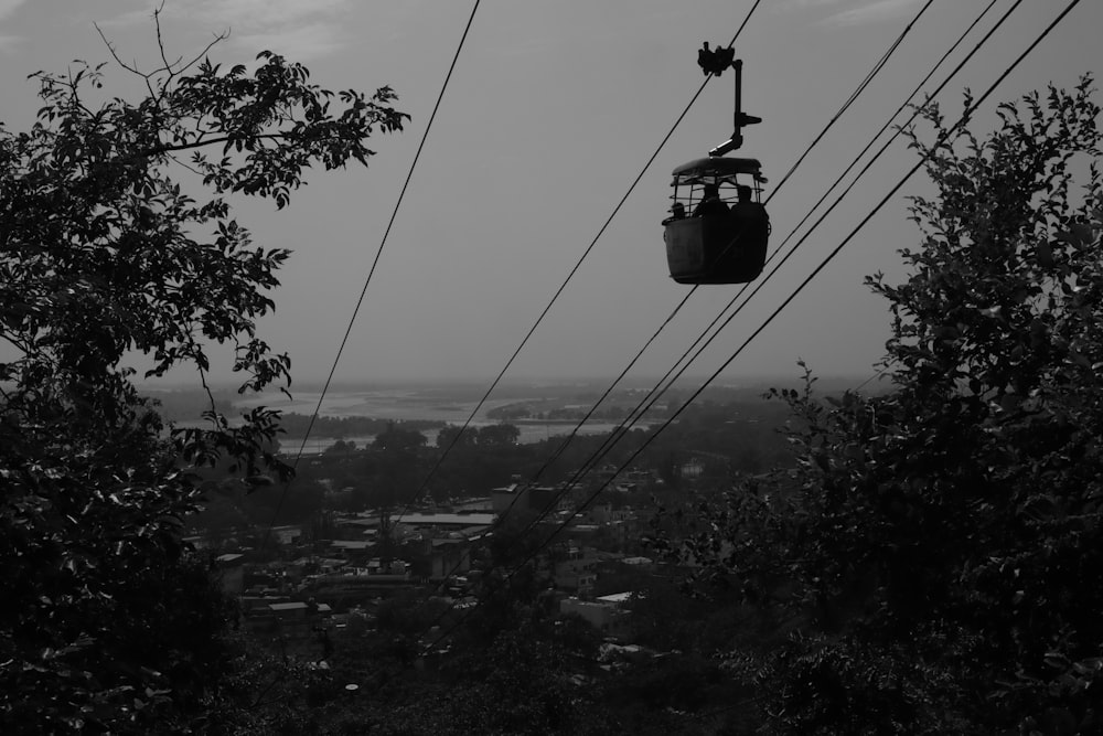 a black and white photo of a cable car