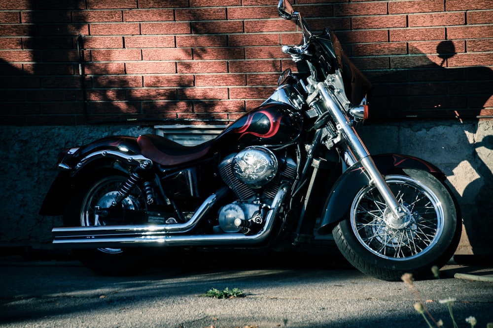 a motorcycle parked next to a brick wall