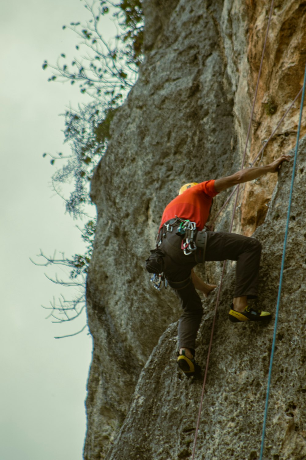 a man climbing up the side of a cliff