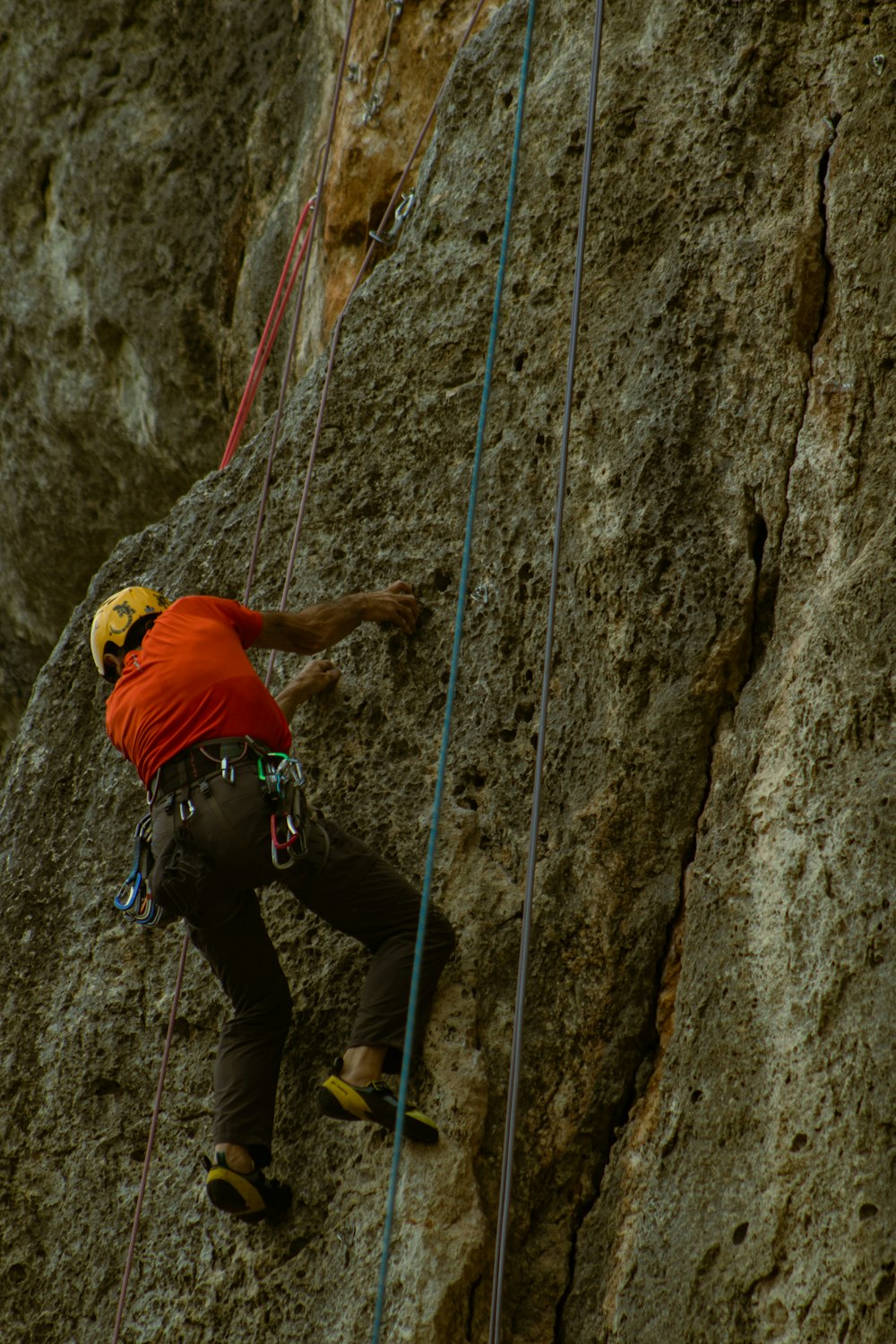 a man climbing up the side of a mountain