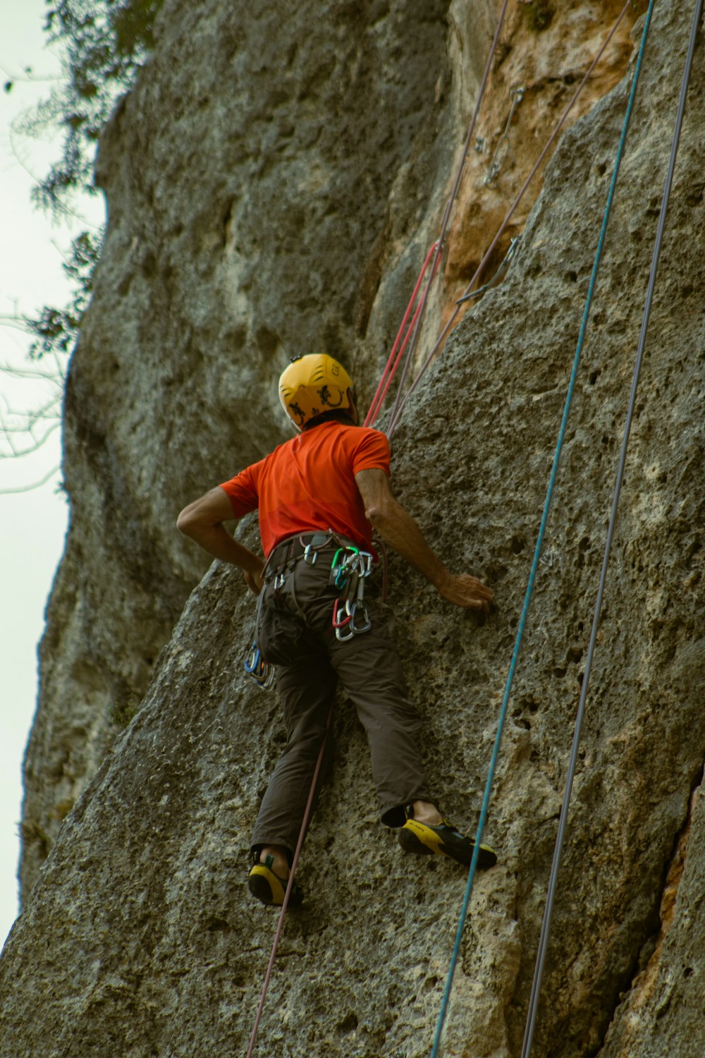 a man climbing up the side of a mountain