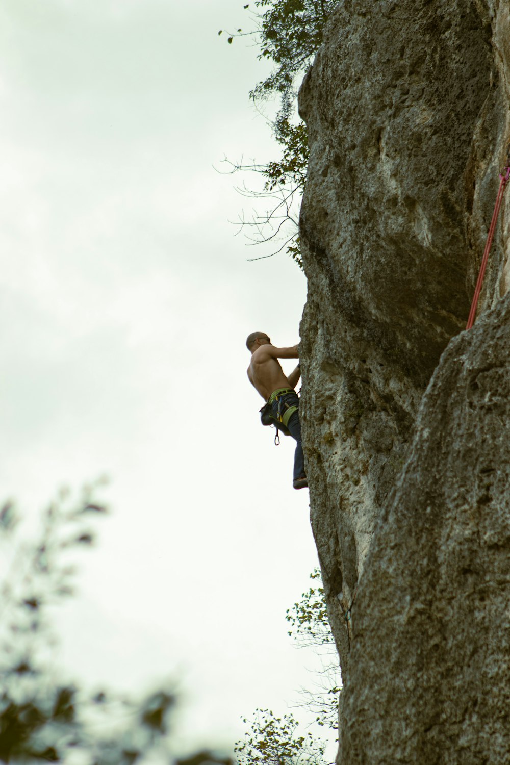 a man climbing up the side of a cliff