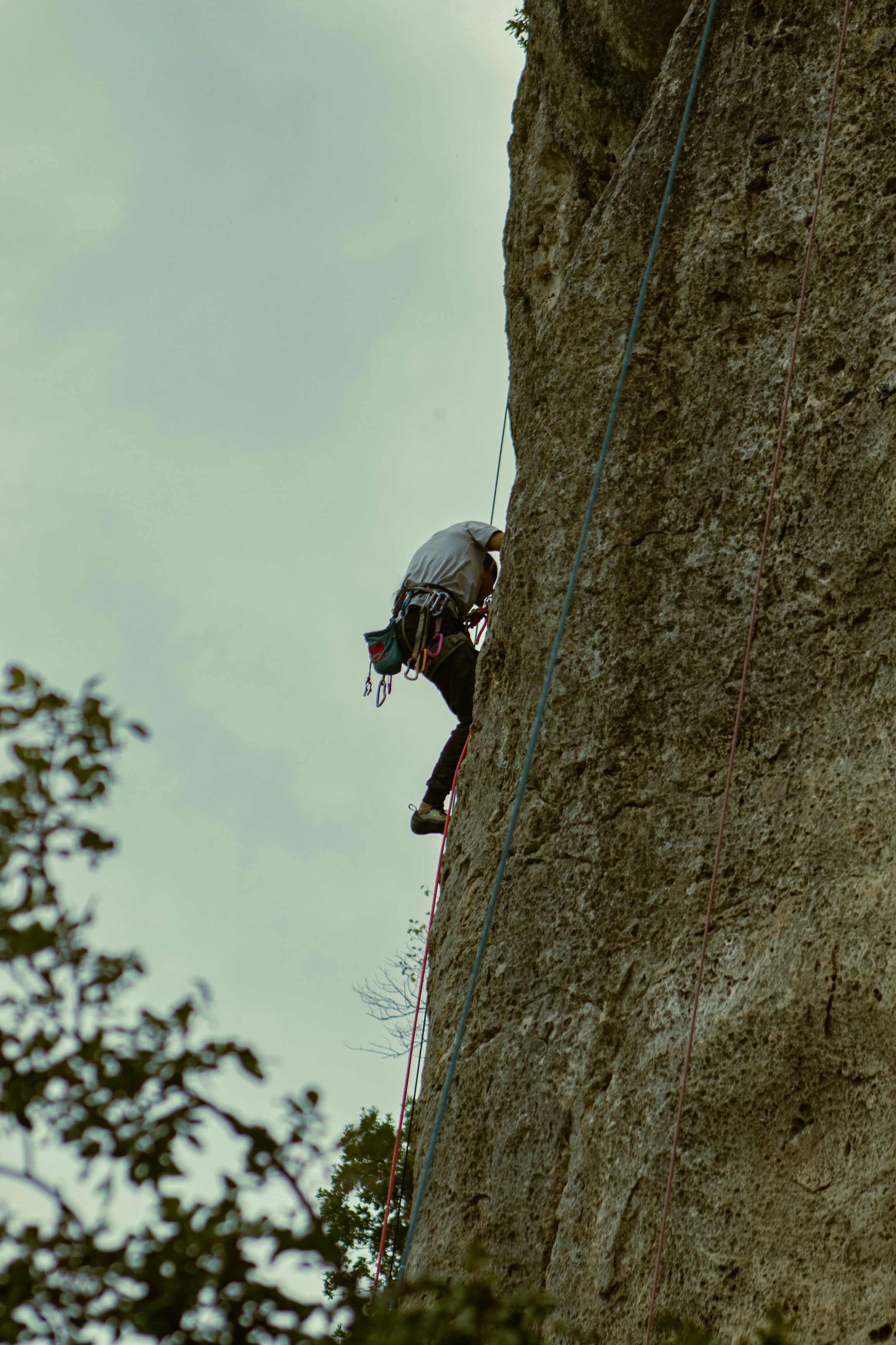 a man climbing up the side of a cliff