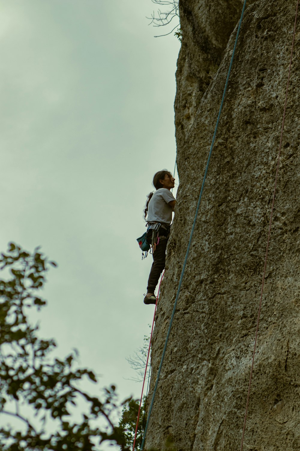 a man climbing up the side of a cliff