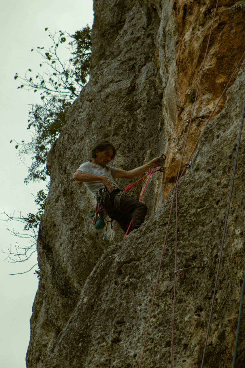 a man climbing up the side of a cliff