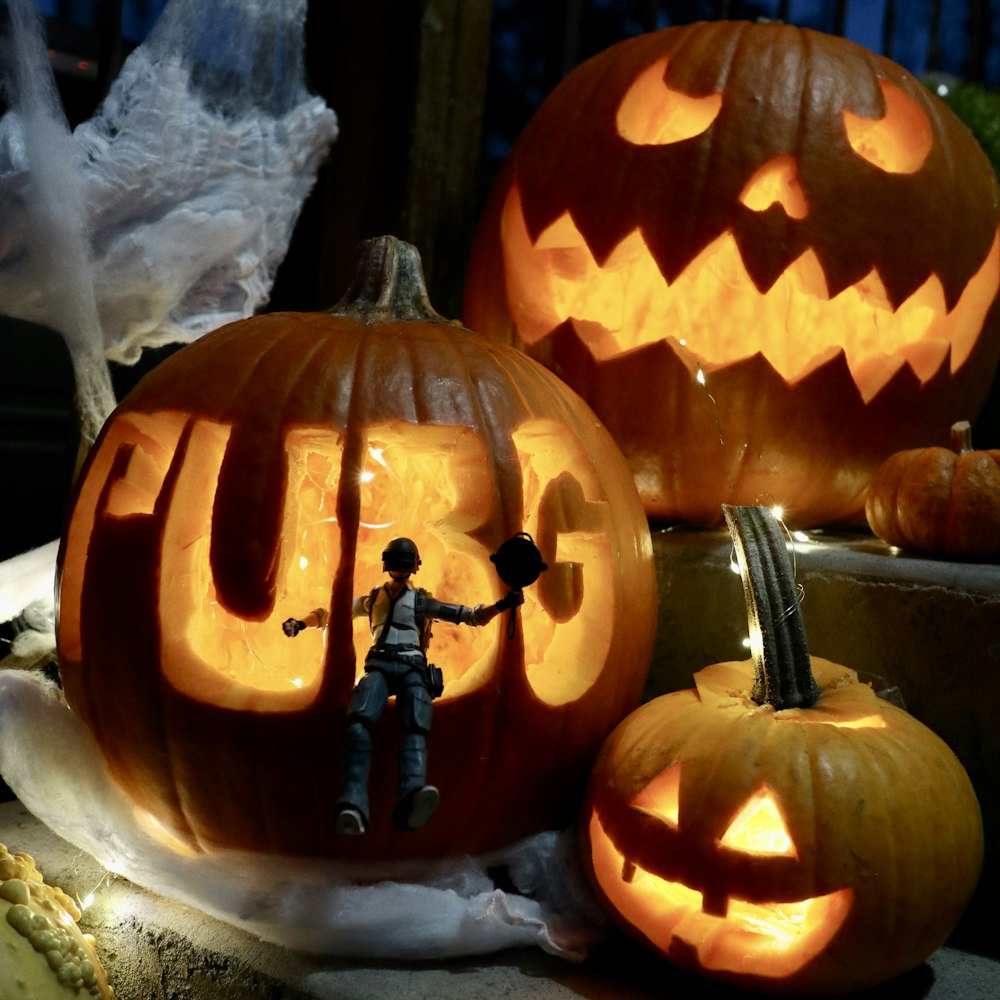 a couple of carved pumpkins sitting on top of a table