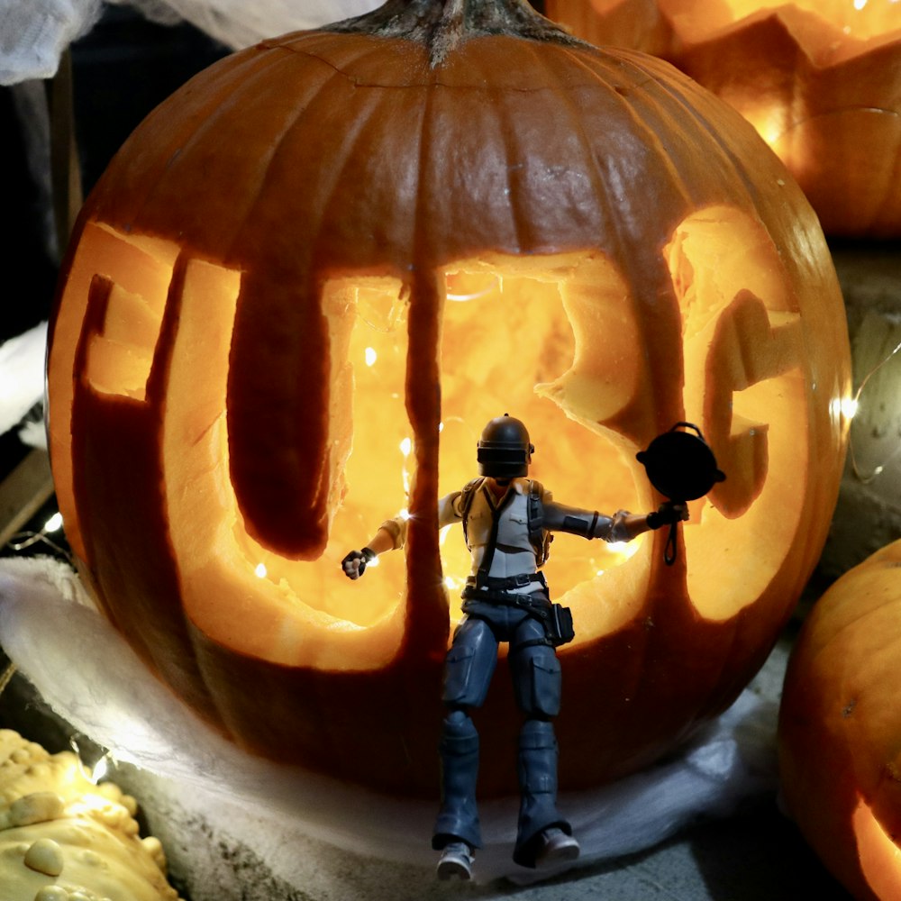 a person carving a pumpkin with the word cut out