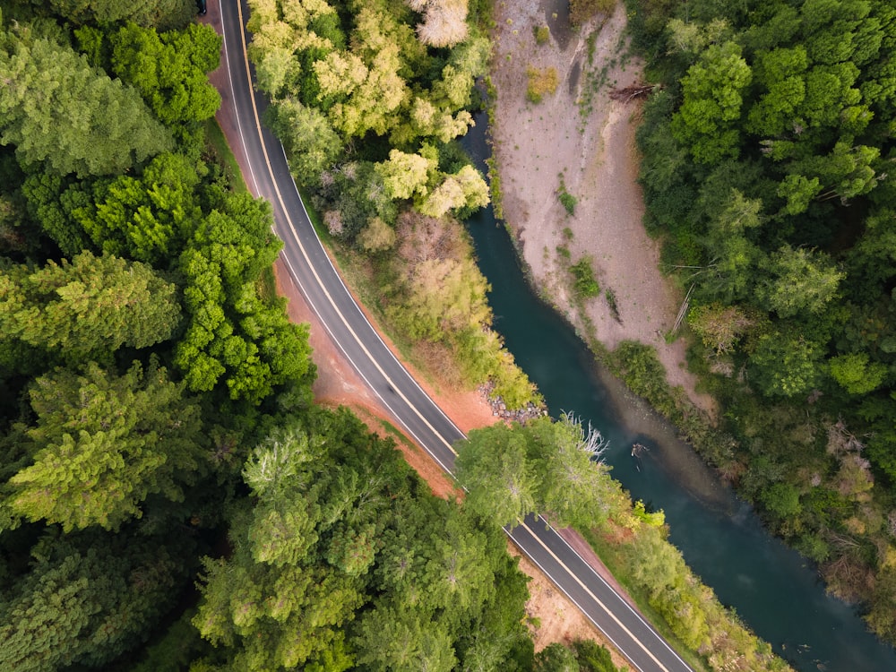 an aerial view of a winding road surrounded by trees