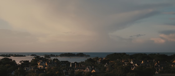 A scenic view of a coastal village in Portugal at sunset.