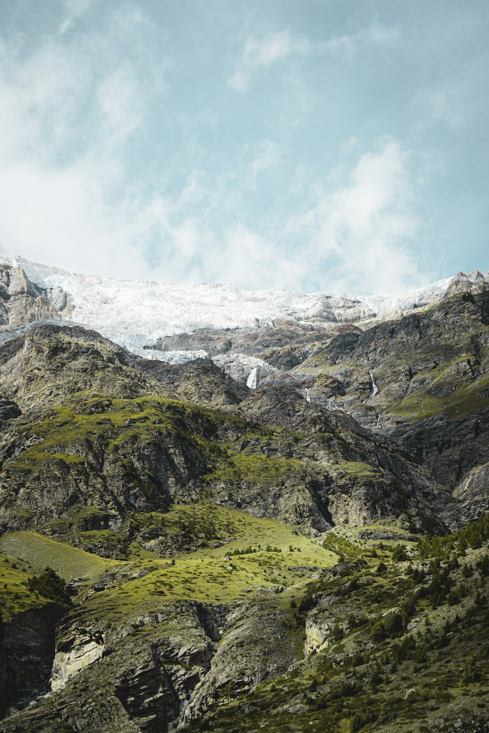 a view of a mountain range with snow on the top