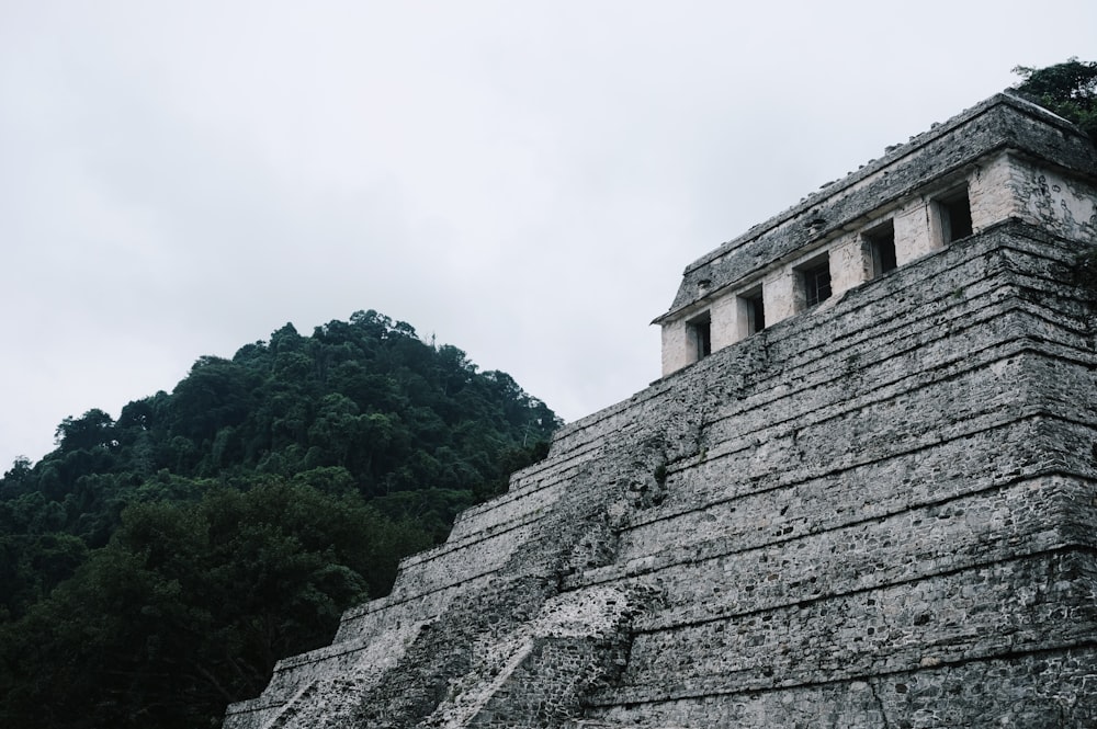 a large stone structure with two windows on top of it