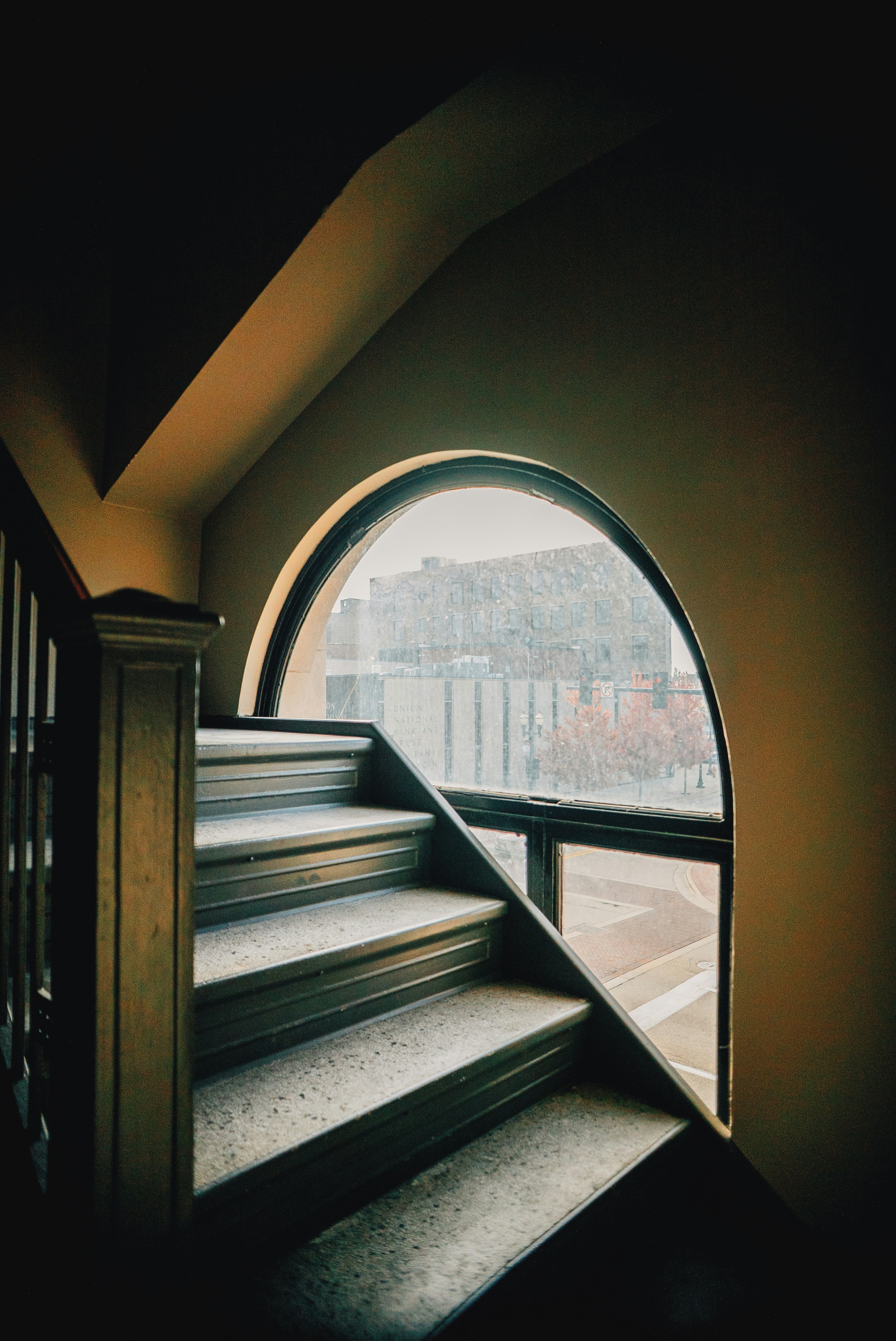 a circular window on the side of a staircase