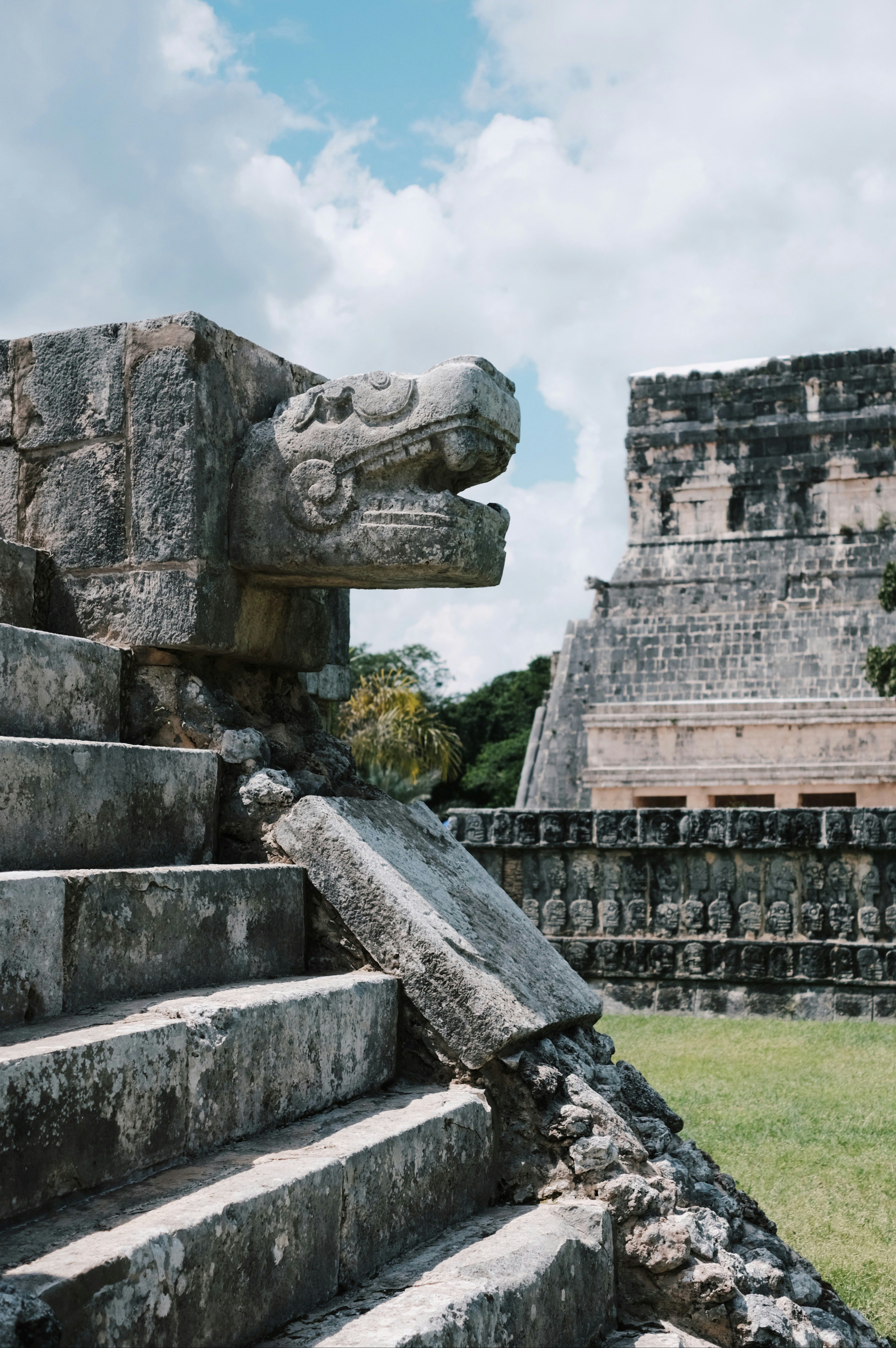 a stone staircase with a gargoyle head on top of it