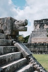 a stone staircase with a gargoyle head on top of it