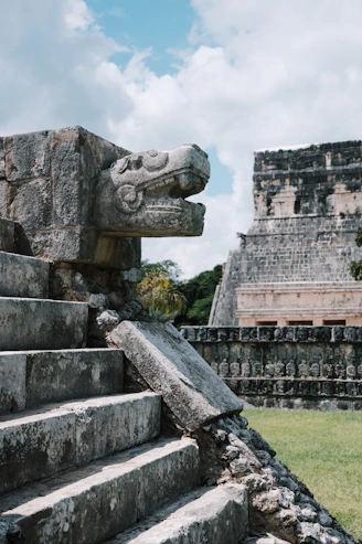 a stone staircase with a gargoyle head on top of it