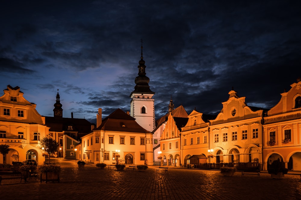 a building with a clock tower lit up at night