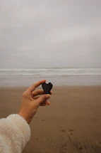 A gentle hand holding a smooth stone symbolizing calm and connection.