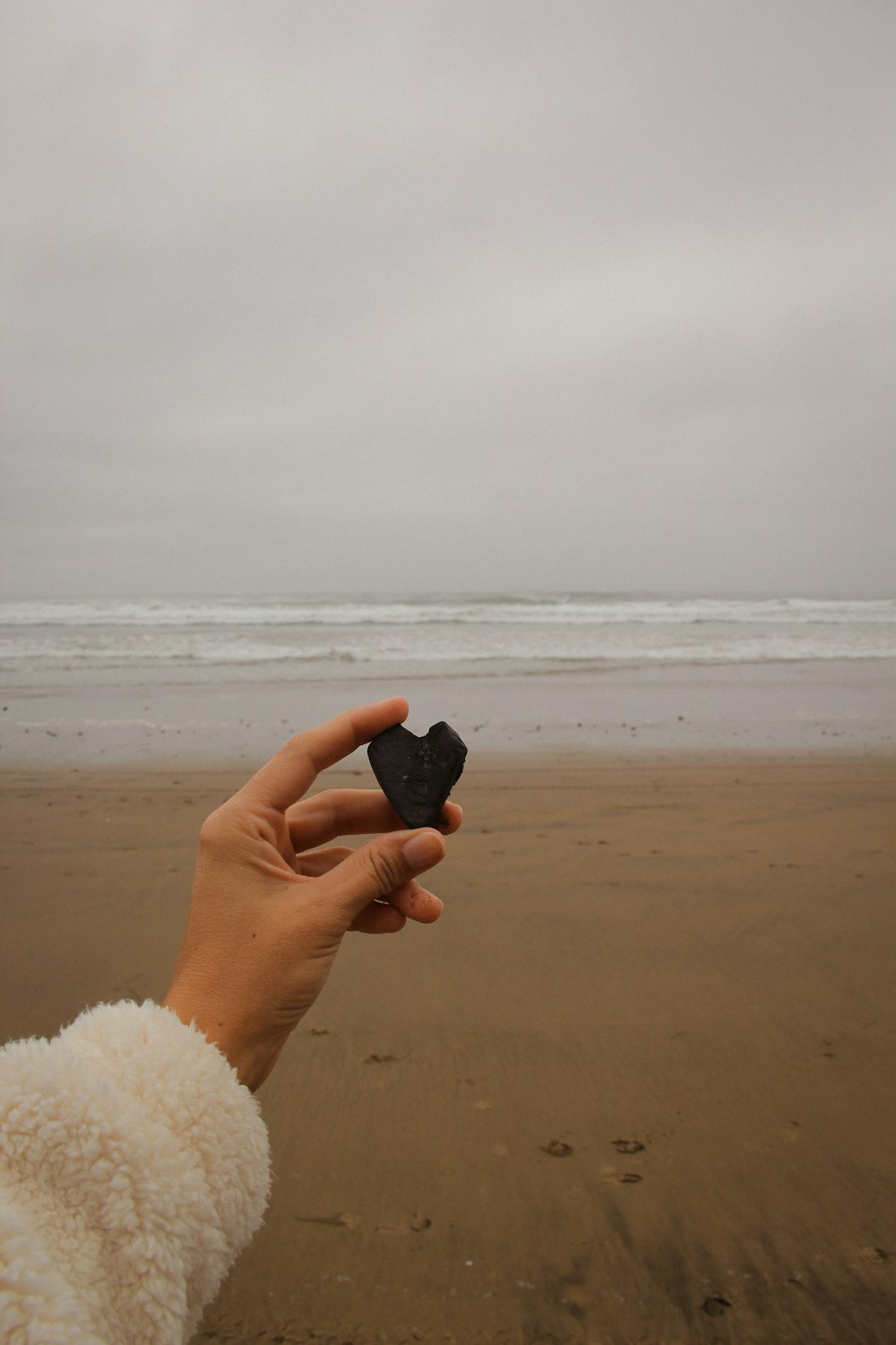 a person holding a small object in their hand