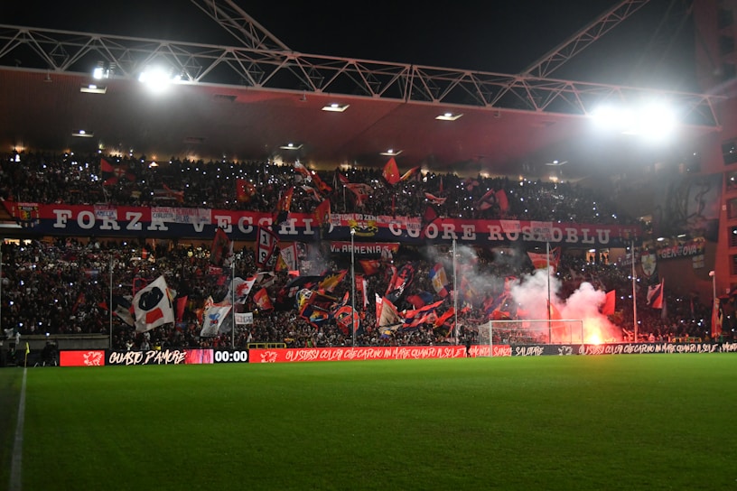 A vibrant stadium filled with passionate Brazilian football fans waving flags.