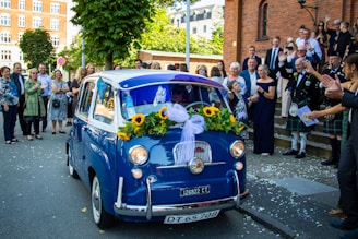 A cozy family gathering around a vintage car with music playing softly in the background.