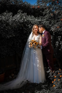 Bride and groom exchanging vows beneath blooming sunflowers on the estate grounds.