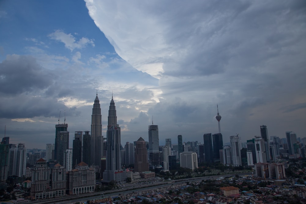 a view of a city with tall buildings under a cloudy sky