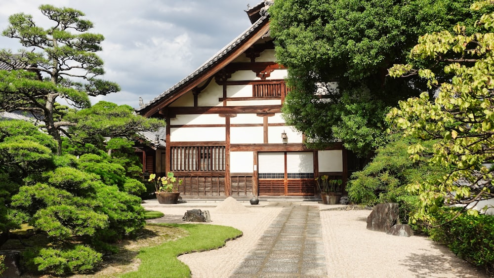 a white and brown building surrounded by trees