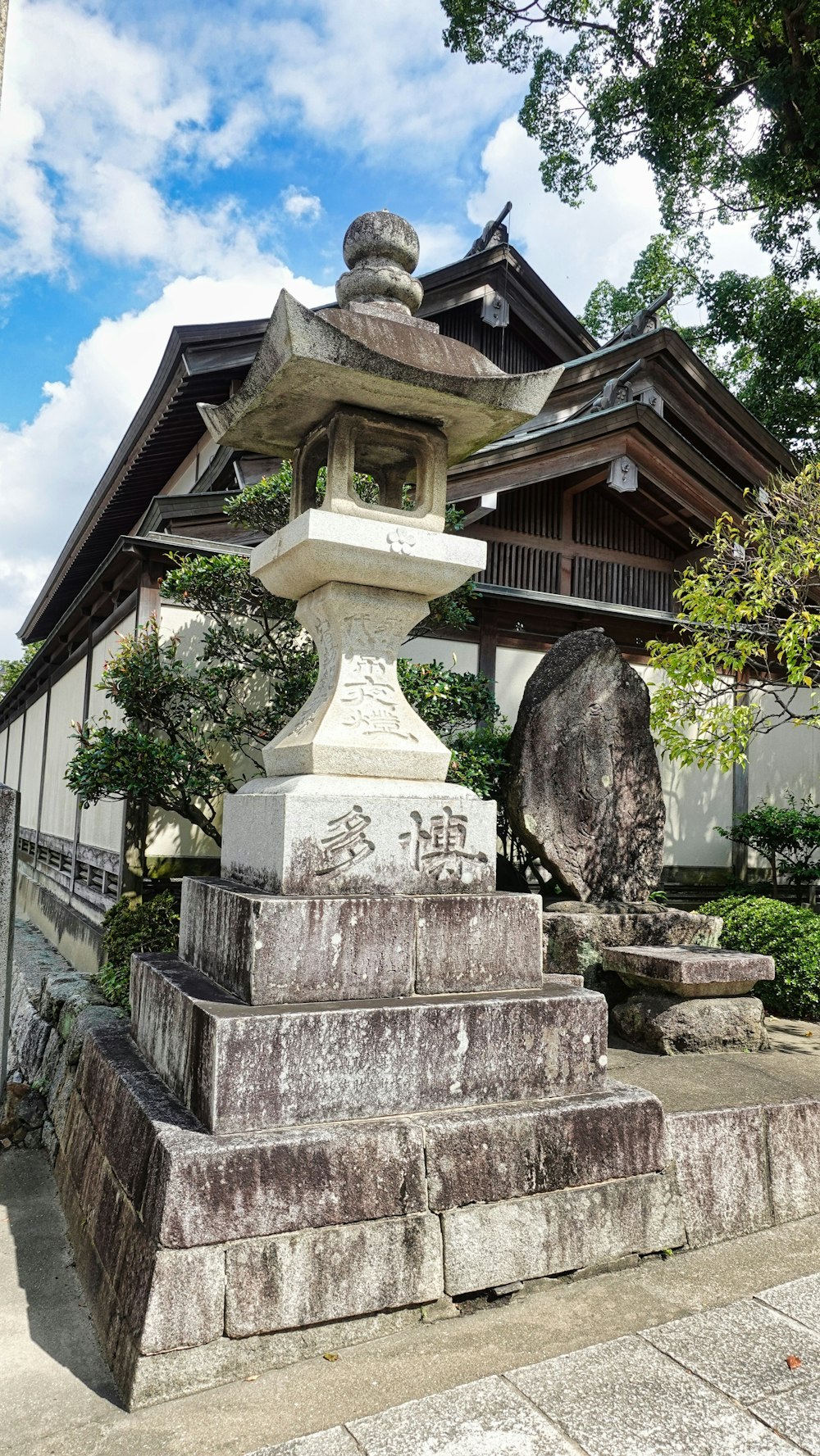 a stone statue in front of a building