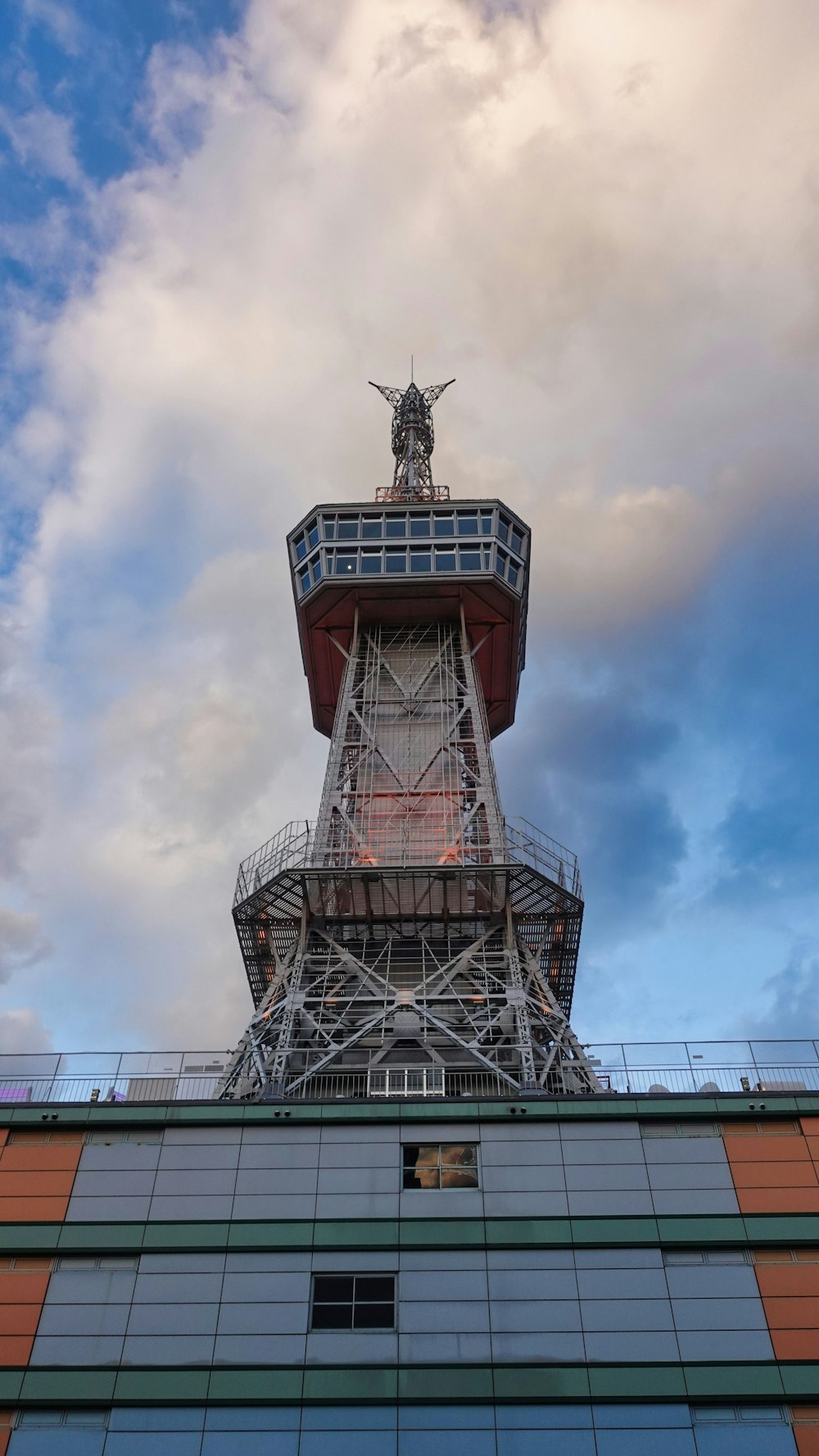 a tall tower with a statue on top of it