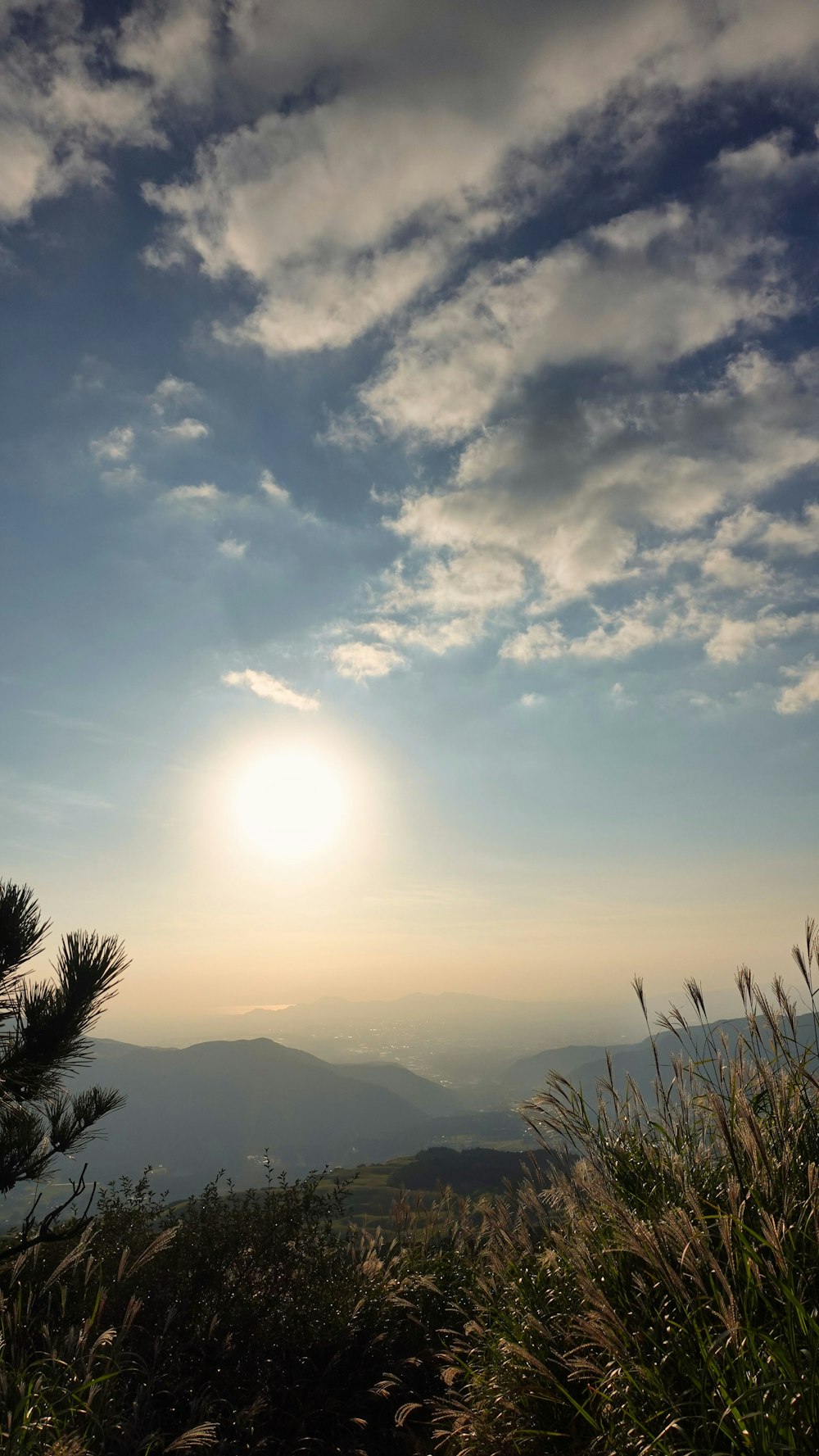 the sun is setting over a mountain range