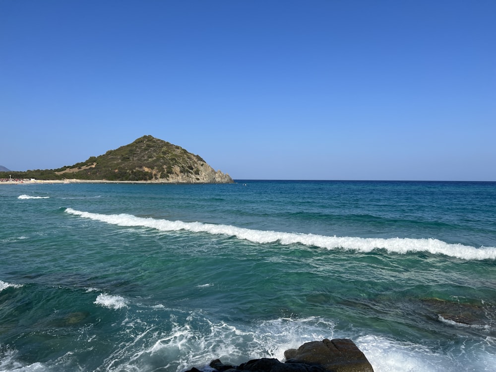 a body of water with a small island in the distance