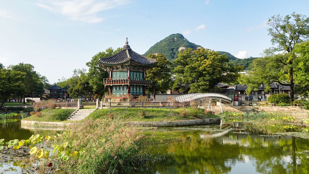 a small building sitting on top of a lush green hillside