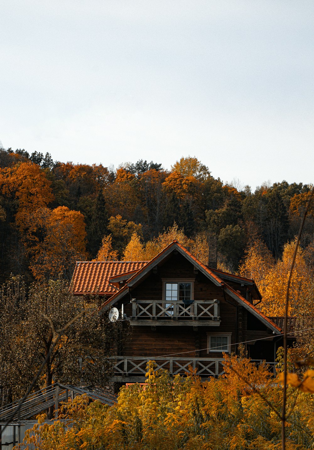 a wooden cabin with a red roof surrounded by trees