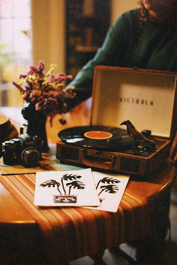 A cozy vintage radio surrounded by vinyl records and purple-hued ambient lighting.