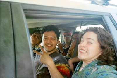 A group of college students sharing a ride in a car.
