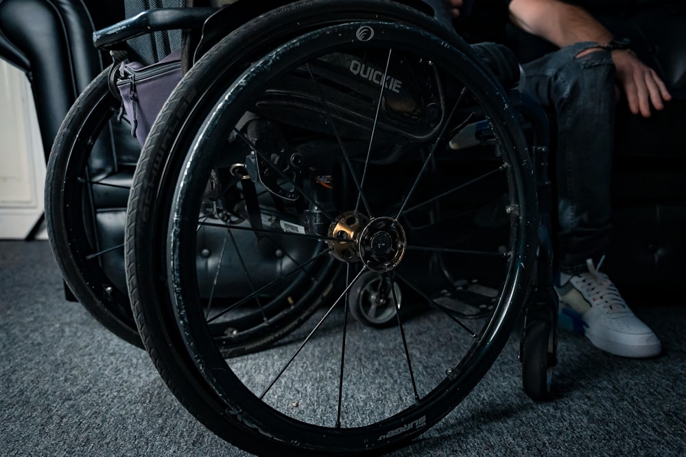 a man sitting in a chair with a wheel on it